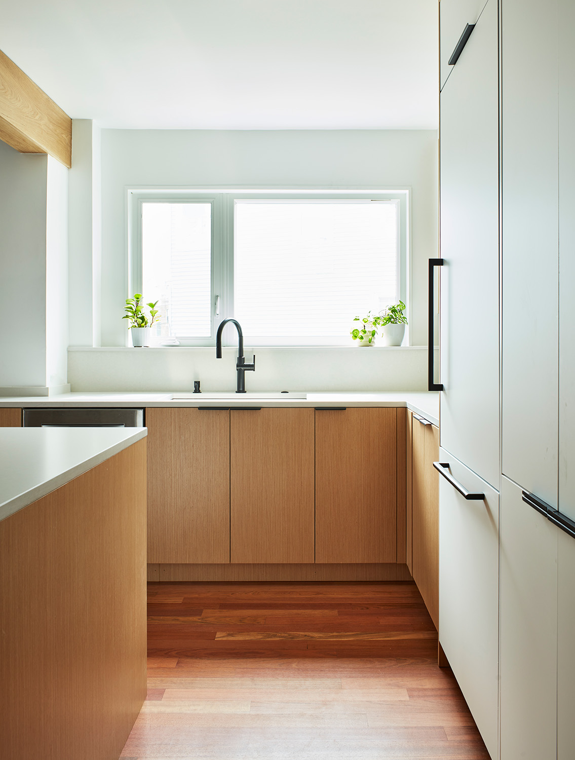 The rich hardwood floors, in a hue similar to the light oak, help the kitchen come together visually